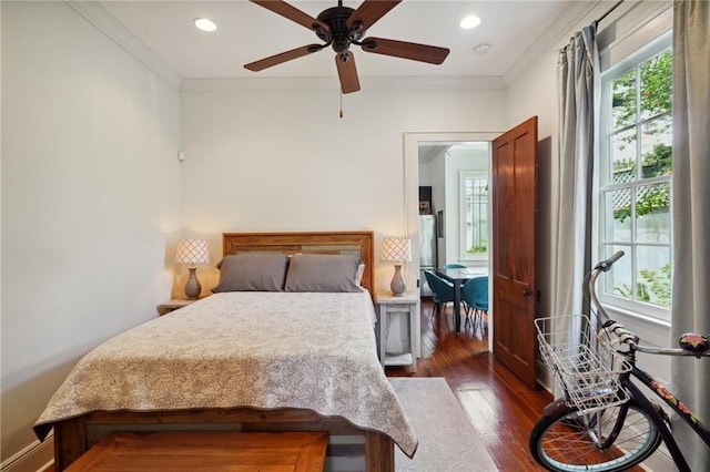 bedroom with ceiling fan, dark hardwood / wood-style floors, and ornamental molding