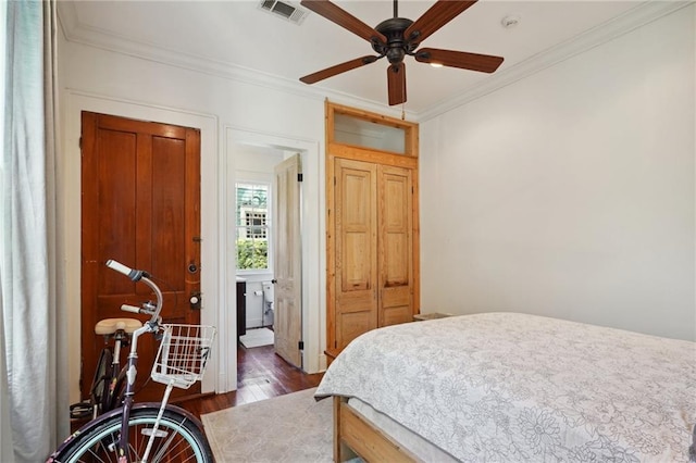 bedroom with crown molding, dark hardwood / wood-style floors, and ceiling fan