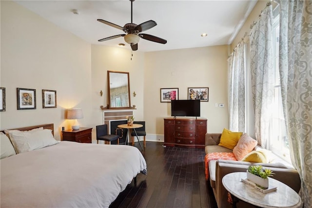 bedroom with ceiling fan and dark hardwood / wood-style flooring