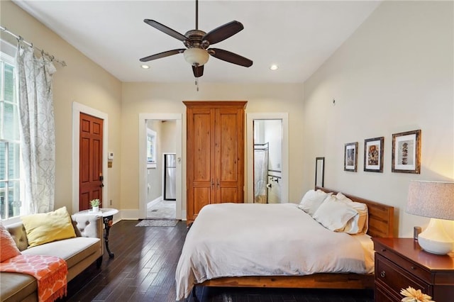 bedroom with ensuite bathroom, dark hardwood / wood-style floors, and ceiling fan