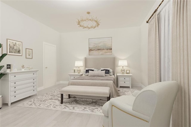 bedroom with baseboards and wood finished floors