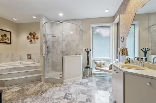 bathroom with vanity, recessed lighting, a stall shower, a bath, and marble finish floor