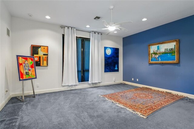 unfurnished room with visible vents, baseboards, ceiling fan, and carpet floors