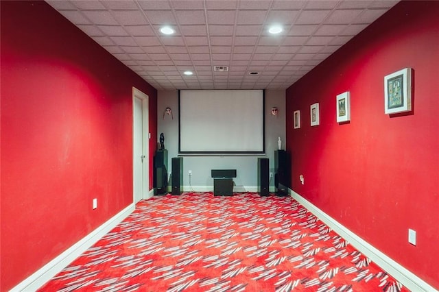 cinema room featuring a drop ceiling, recessed lighting, visible vents, and baseboards