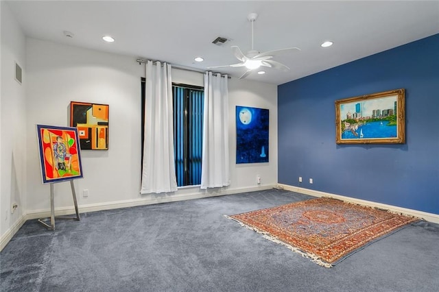 unfurnished room featuring baseboards, visible vents, carpet floors, and ceiling fan