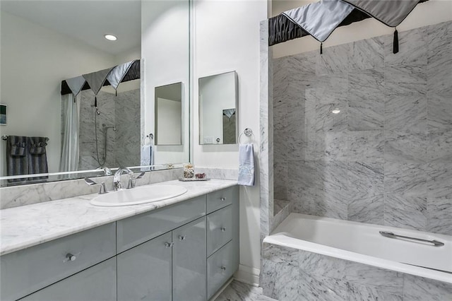 bathroom with a shower, a tub with marble appearance, marble finish floor, and vanity