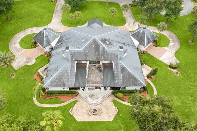 view of front of house featuring stucco siding, an attached garage, a chimney, and a front yard