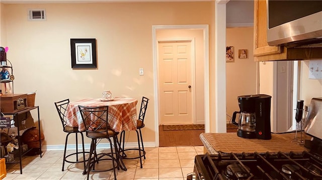 dining space with light tile floors