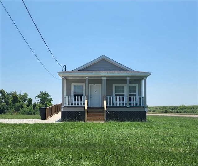 view of front of property with covered porch and a front lawn