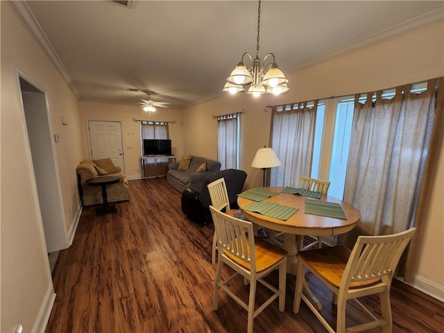 dining space with ornamental molding, dark hardwood / wood-style floors, and ceiling fan with notable chandelier