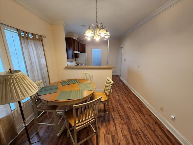 dining space with dark hardwood / wood-style flooring, a notable chandelier, and ornamental molding