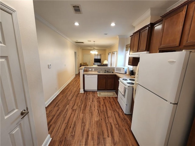 kitchen with sink, crown molding, white appliances, dark hardwood / wood-style floors, and kitchen peninsula