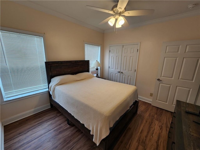 bedroom with ornamental molding, dark hardwood / wood-style floors, ceiling fan, and a closet