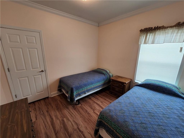 bedroom with crown molding and dark wood-type flooring