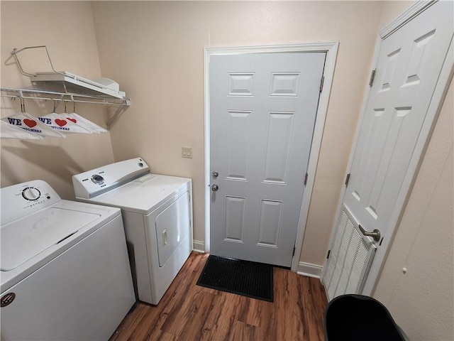 laundry room with dark wood-type flooring and independent washer and dryer