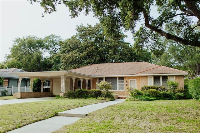 single story home with a front yard and a carport