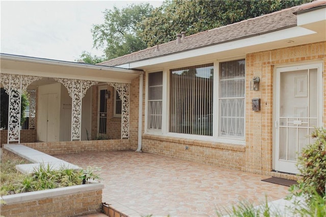 entrance to property featuring a patio