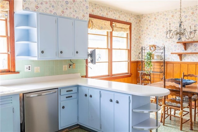 kitchen featuring decorative light fixtures, dishwasher, a chandelier, decorative backsplash, and kitchen peninsula