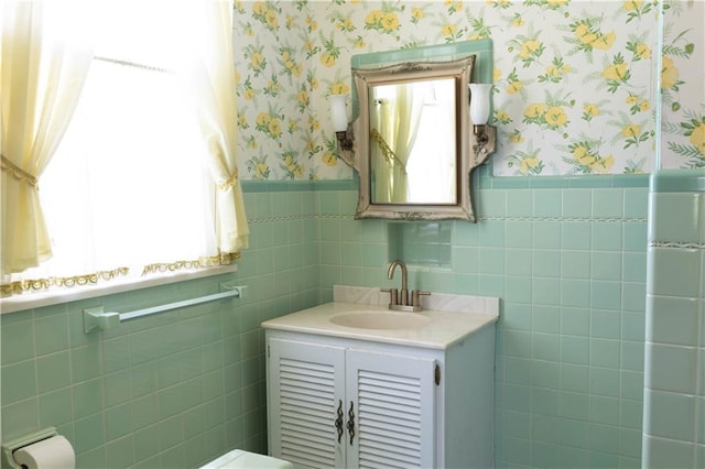 bathroom featuring vanity and tile walls