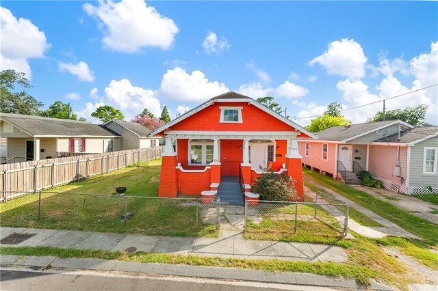 bungalow-style house featuring a front yard