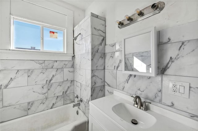 bathroom with tiled shower / bath combo and vanity