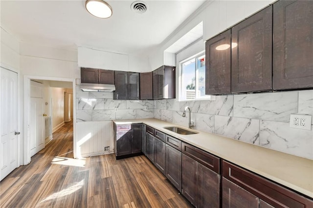 kitchen with dark brown cabinets, sink, tasteful backsplash, and dark hardwood / wood-style flooring