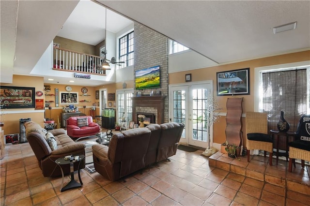 living room featuring tile patterned floors, a fireplace, and french doors