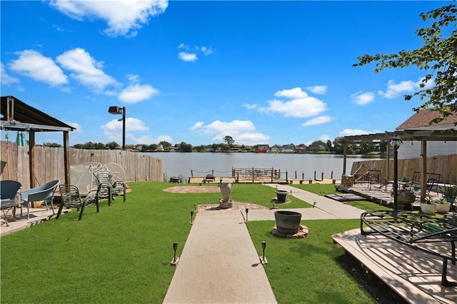 surrounding community featuring a yard, a pergola, a patio area, and a water view