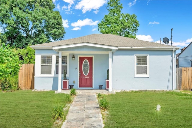 bungalow with a front yard and a porch