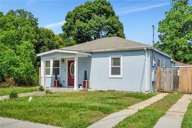 5611 Arts St, New Orleans, LA 70122 - bungalow featuring stucco siding, a porch, cooling unit, and roof with shingles