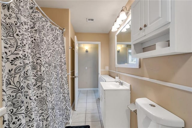5611 Arts St, New Orleans, LA 70122 - bathroom featuring toilet, tile patterned flooring, vanity, and a shower with shower curtain