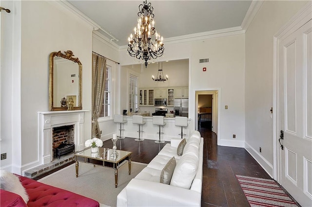 living room with dark hardwood / wood-style flooring, a notable chandelier, and ornamental molding