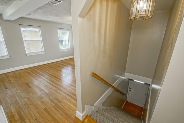 staircase featuring wood-type flooring