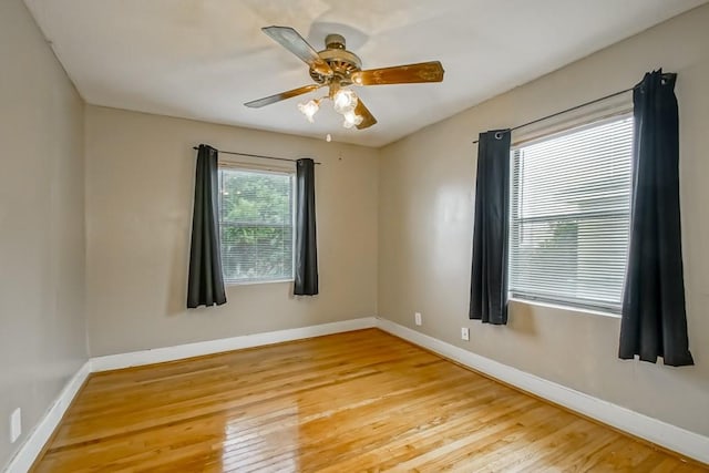 empty room featuring ceiling fan and light hardwood / wood-style floors