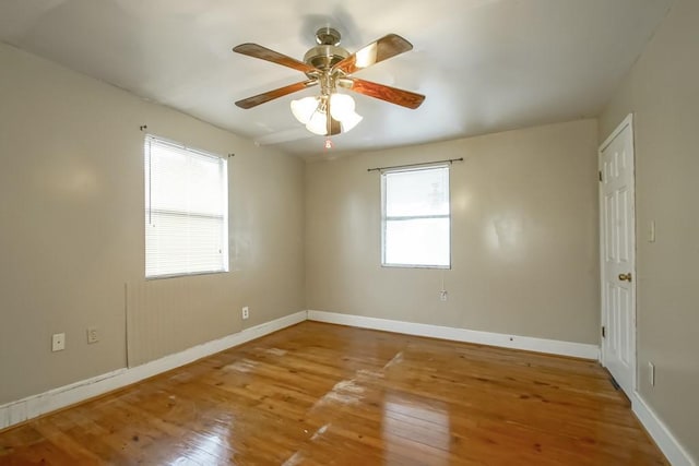 spare room with hardwood / wood-style floors and ceiling fan