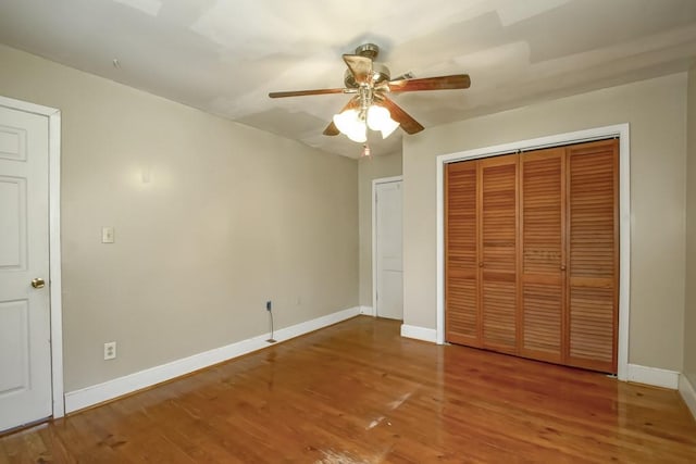 unfurnished bedroom featuring ceiling fan and hardwood / wood-style flooring