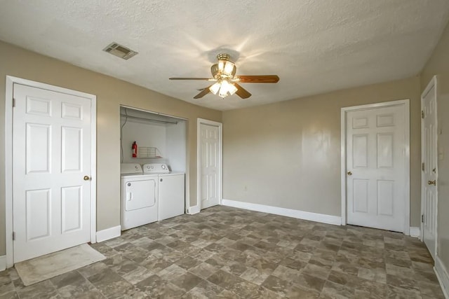 laundry area with ceiling fan, separate washer and dryer, and a textured ceiling