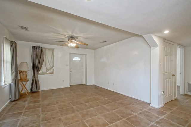 foyer featuring ceiling fan and light tile patterned floors