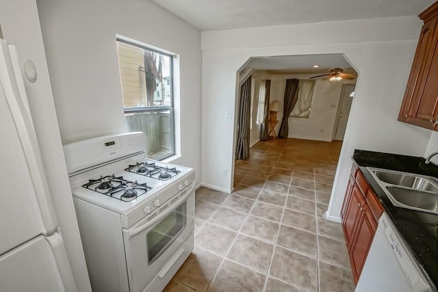 kitchen with ceiling fan, white appliances, sink, and light tile patterned floors