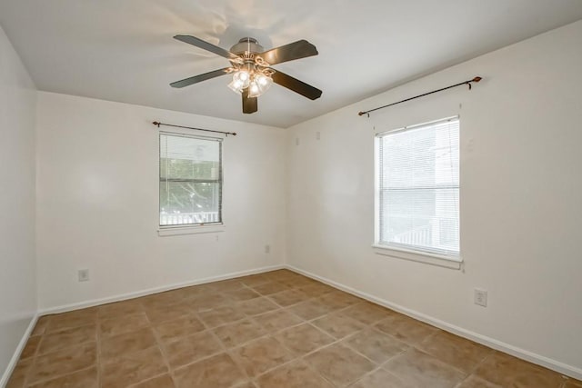 unfurnished room with ceiling fan and light tile patterned flooring