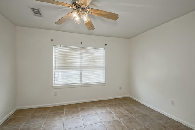 spare room featuring ceiling fan and light tile patterned floors