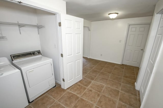 laundry room with light tile patterned floors and separate washer and dryer