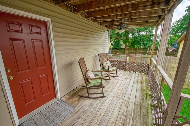 wooden terrace featuring a porch and ceiling fan