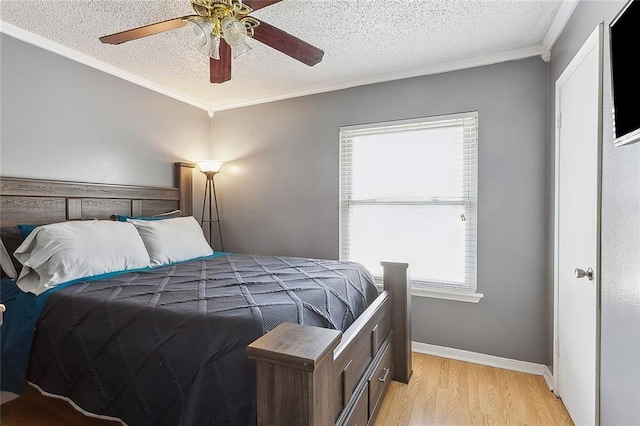 bedroom featuring crown molding, ceiling fan, a textured ceiling, and light wood-type flooring