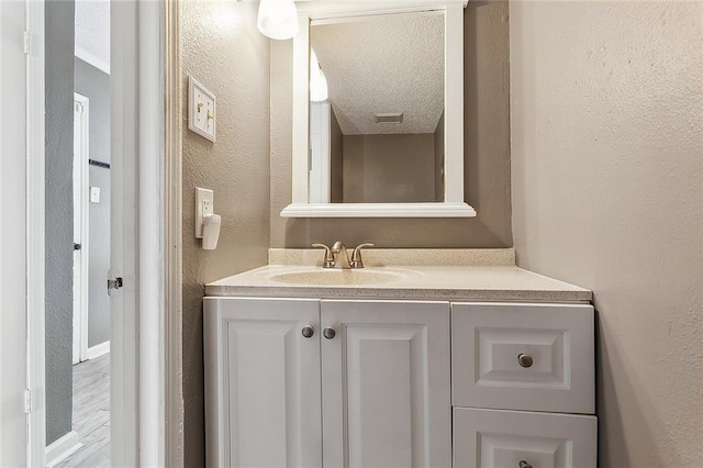 bathroom featuring vanity and a textured ceiling