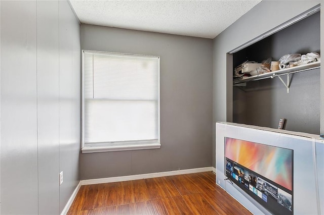 interior space featuring hardwood / wood-style flooring and a textured ceiling