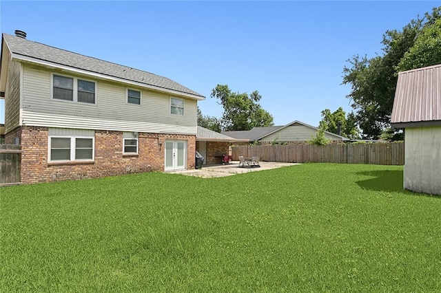 back of house with a lawn, a patio, and french doors