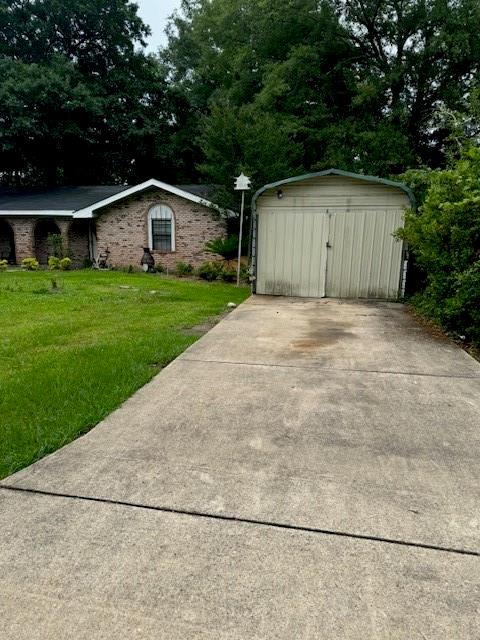 view of side of home with a yard and a shed