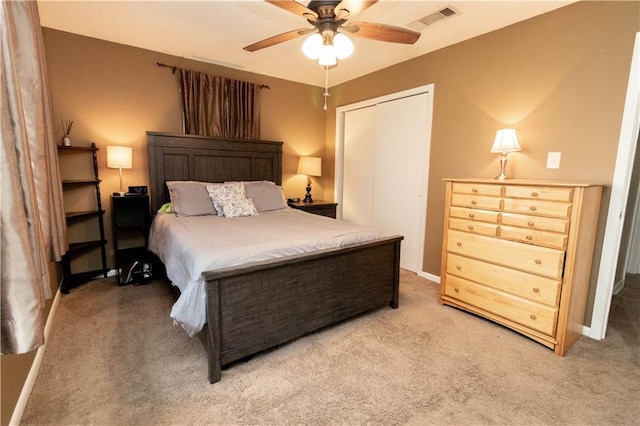 carpeted bedroom featuring a closet and ceiling fan