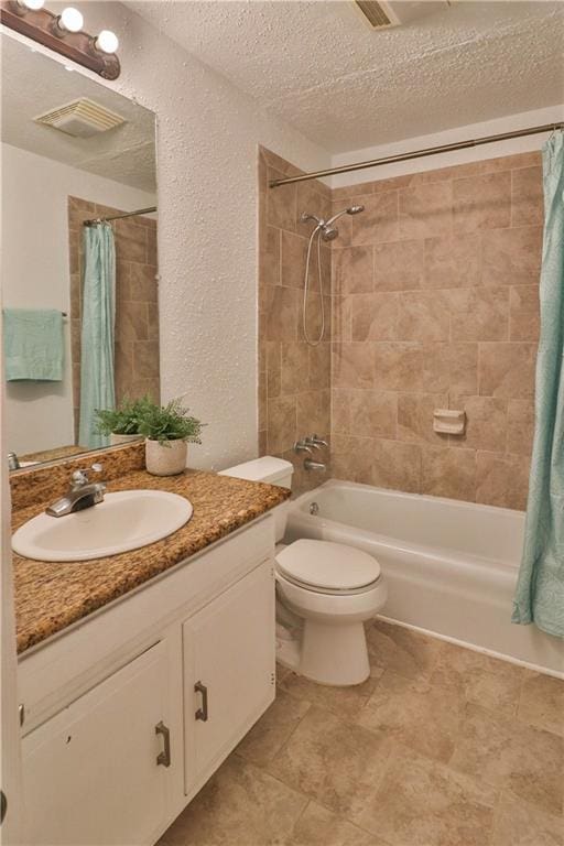 full bathroom featuring vanity, shower / bath combo, a textured ceiling, and toilet